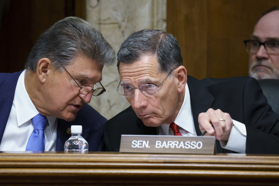 FILE - Sen. Joe Manchin, D-W.Va., chair of the Senate Energy and Natural Resources Committee, left, holds a hearing with Ranking Member Sen. John Barrasso, R-Wyo., at the Capitol in Washington on June 23, 2021. A proposal from the Biden administration would enshrine conservation as an "equal" use of federal land alongside oil and gas drilling, mining, grazing and other activities. (AP Photo/J.