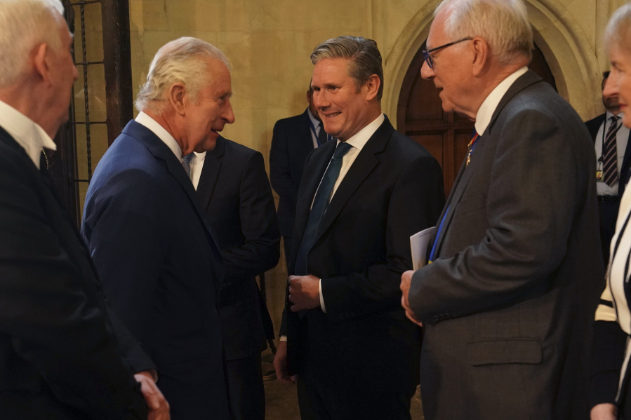 Britain's King Charles III, second left, speaks with Labour leader Keir Starmer, during a visit to Westminster Hall at the Palace of Westminster to attend a reception ahead of the coronation, in London, Tuesday May 2, 2023.