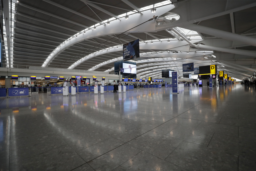 FILE - Terminal 5 at Heathrow Airport in London, which handles British Airways flights, stands virtually empty of passengers as staff standby to help during a British Airways pilots' strike, Monday, Sept. 9, 2019. The British government is working to fix a technical problem that caused electronic border gates at airports around the country to stop working late Friday, leading to hourslong waits for travelers entering the U.K. at the start of a busy holiday weekend.