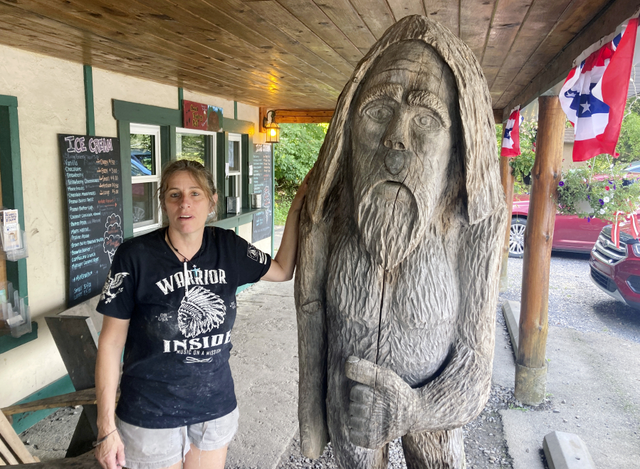 FILE - Pauline Bauer leans against a wooden statue outside Bob's Trading Post, her restaurant in Hamilton, Pa., July 21, 2021. Bauer, who screamed death threats directed at then-House Speaker Nancy Pelosi while storming the U.S. Capitol on Jan. 6, 2021, was sentenced on Tuesday to two years and three months in prison.