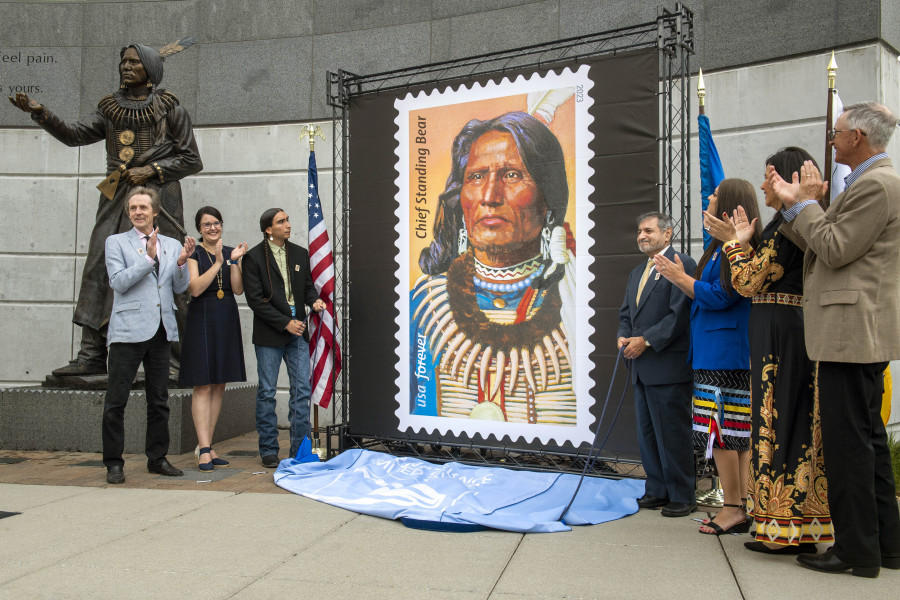The Chief Standing Bear stamp is being unveiled by attendees from left, University of Nebraska-Lincoln journalism professor Joe Starita, Lincoln Parks and Recreation director Maggie Stuckey-Ross, Steve Laravie Jr., a descendant of Standing Bear, U.S. Postal Service Board of Governors vice chairman Anton Hajjar, Ponca tribal chairwoman Candace Schmidt, Nebraska Indian Affairs executive director Judi M. gaiashkibos, Friday, May 12, 2023, in Lincoln, Neb. Chief Standing Bear, a Ponca tribe chief whose landmark lawsuit in 1879 established that a Native American is a person under the law was honored Friday with the unveiling of a U.S.