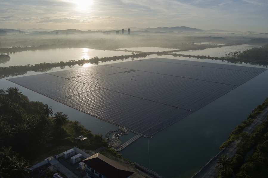 The sun rises over floating solar panels on May 3, 2023, in Selangor, Malaysia. Floating solar panel farms are beginning to boom in the United States after rapid growth in Asia. They're attractive not just for their clean power and lack of a land footprint, but because they also conserve water by preventing evaporation.