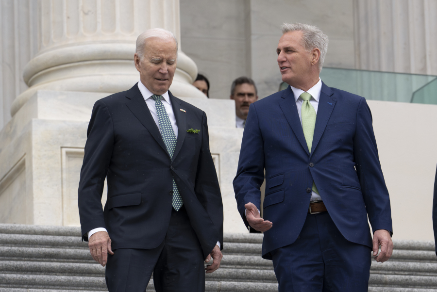 FILE - President Joe Biden walks with House Speaker Kevin McCarthy, R-Calif., as he departs the Capitol following the annual St. Patrick's Day gathering, in Washington, Friday, March 17, 2023. Facing the risk of a government default as soon as June 1, President Joe Biden has invited the top four congressional leaders to a White House meeting for talks. (AP Photo/J.