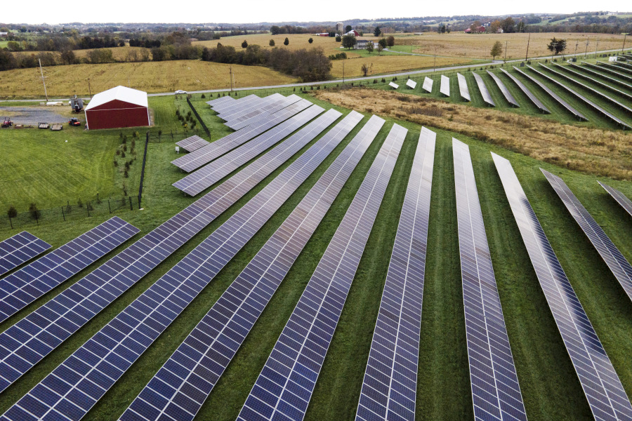 FILE - Farmland is seen with solar panels from Cypress Creek Renewables, Oct. 28, 2021, in Thurmont, Md. The Senate has approved a measure that would reinstate tariffs on solar panel imports from several Southeast Asian countries after President Joe Biden paused them in a bid to boost solar installations in the U.S.