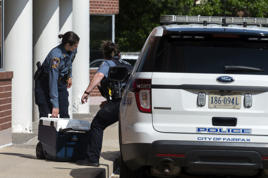 Officers work outside the Fairfax, Va., office building where police say a man wielding a baseball bat attacked two staffers for U.S. Rep. Gerry Connolly, D-Va., on Monday, May 15, 2023. Fairfax City Police in northern Virginia said in a tweet that a suspect is in custody and the victims are being treated for injuries that are not life-threatening.