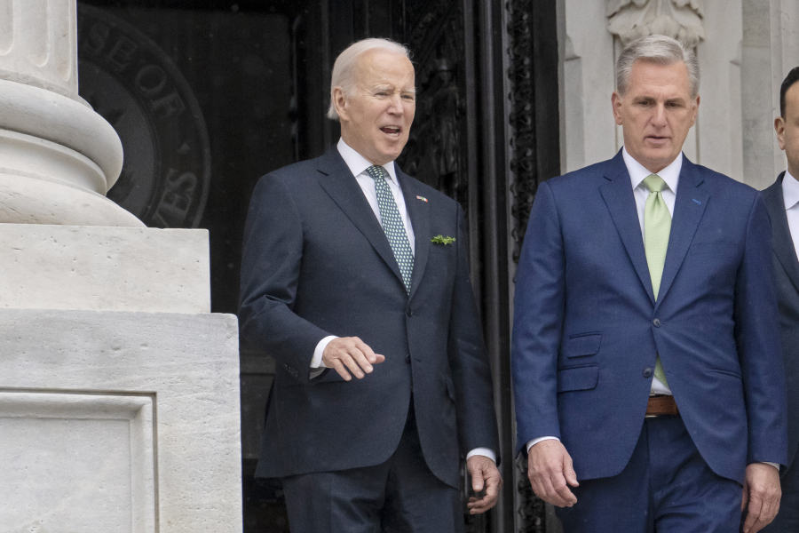 FILE - President Joe Biden talks with House Speaker Kevin McCarthy, R-Calif., as he departs the Capitol following the annual St. Patrick's Day gathering, in Washington, March 17, 2023. Facing the risk of a federal government default as soon as June 1, President Joe Biden has invited the top four congressional leaders to a White House meeting on May 9 for talks. It's the first concrete step toward negotiations on averting a potential economic catastrophe, but there's a long way to go: Biden and Republicans can't even agree on what's up for negotiation.  (AP Photo/J.