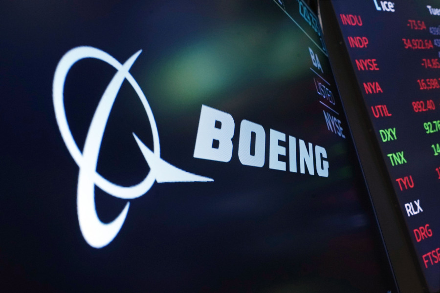 FILE - The logo for Boeing appears on a screen above a trading post on the floor of the New York Stock Exchange, July 13, 2021. Boeing reports earnings on Wednesday, April 26, 2023.