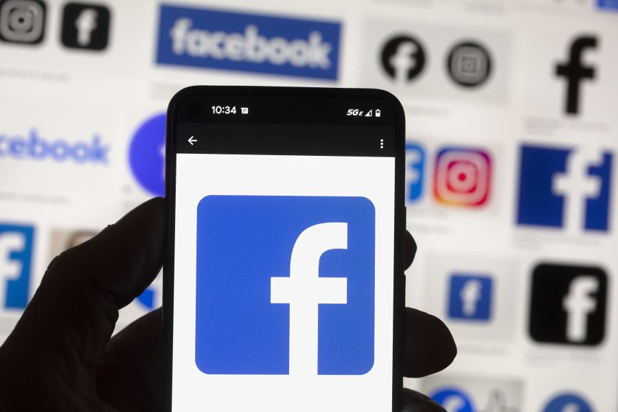 FILE - The Facebook logo is seen on a cell phone, Friday, Oct. 14, 2022, in Boston.  Facebook says it is not dead. It's not even just for "old people," as young people have been saying for years. The social media platform born before the iPhone is approaching two decades in existence.