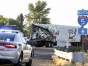 FILE - The back end of a semitruck sits along Interstate 5, Thursday, May 18, 2023, in Marion County, Ore. The semitruck driver involved in the crash on Interstate 5 earlier in the month that left seven farmworkers dead has been indicted on charges of manslaughter. Court documents show that a grand jury in Marion County Court on Tuesday, May 30, indicted Lincoln Smith on 12 counts, including manslaughter and driving under the influence.