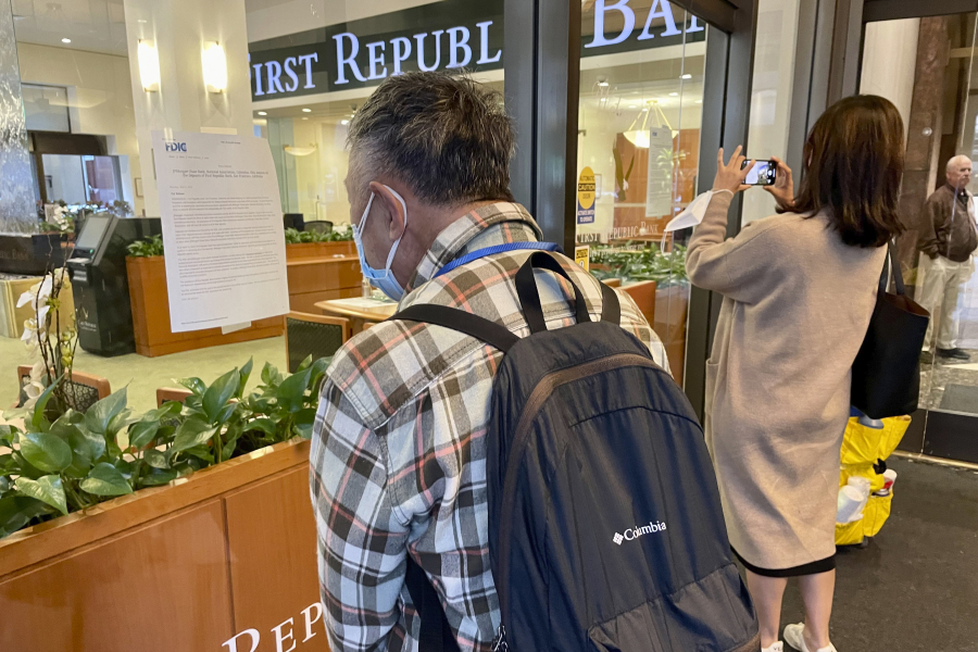 Customers read an announcement in the window of a First Republic Bank branch by their headquarters in San Francisco, Monday, May 1, 2023. Regulators seized troubled First Republic Bank early Monday, making it the second-largest bank failure in U.S. history, and promptly sold all of its deposits and most of its assets to JPMorgan Chase Bank in a bid to head off further banking turmoil in the U.S.