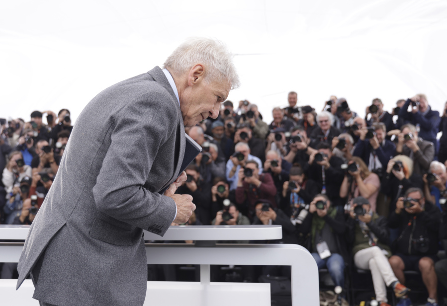 Harrison Ford poses for photographers with his honorary Palme d'Or at the photo call for the film 'Indiana Jones and the Dial of Destiny' at the 76th international film festival, Cannes, southern France, Friday, May 19, 2023.