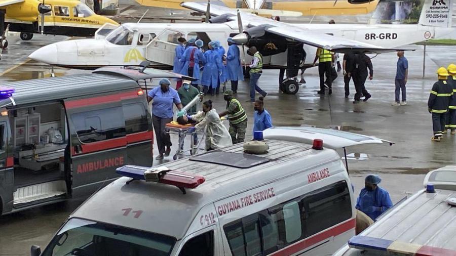 Injured children arrive to the airport in Georgetown, Guyana, Monday, May 22, 2023. A nighttime fire raced through a secondary school dormitory in the town of Mahdia early Monday, killing at least 20 students and injuring several others, authorities said.