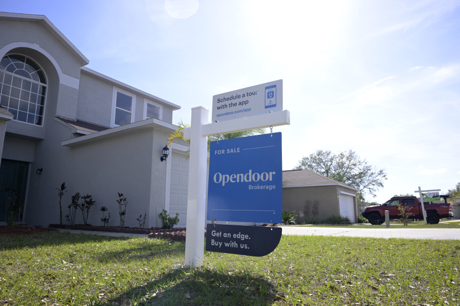 File - Real estate signs are posted outside homes for sale, Tuesday, Feb. 21, 2023, in Valrico, Fla. On Thursday, the National Association of Realtors reports on sales of existing homes in March. (AP Photo/Phelan M.