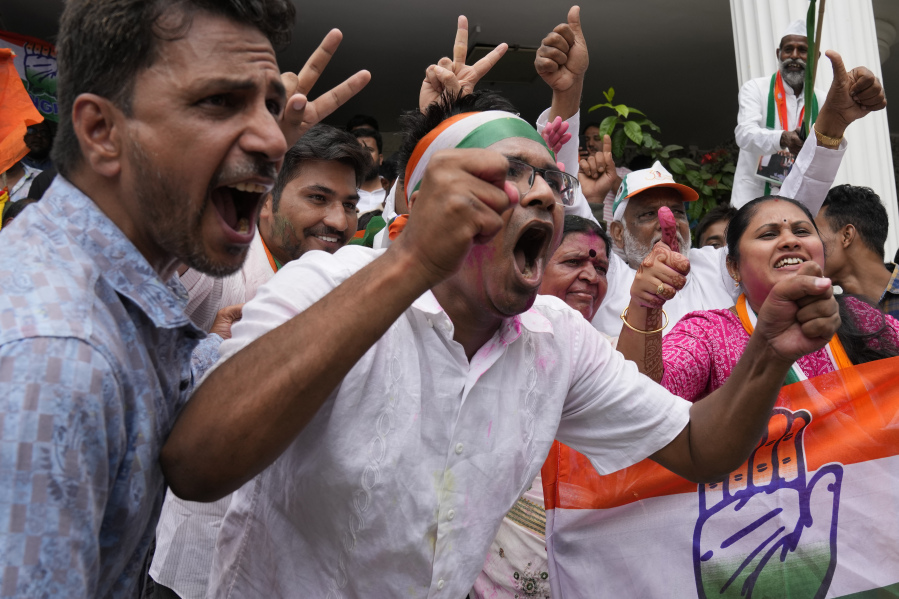 Supporters of opposition Congress party celebrate early leads for the party in the Karnataka state elections in Bengaluru, India, Saturday, May 13, 2023. Elections in India's southern state of Karnataka were held on May 10.