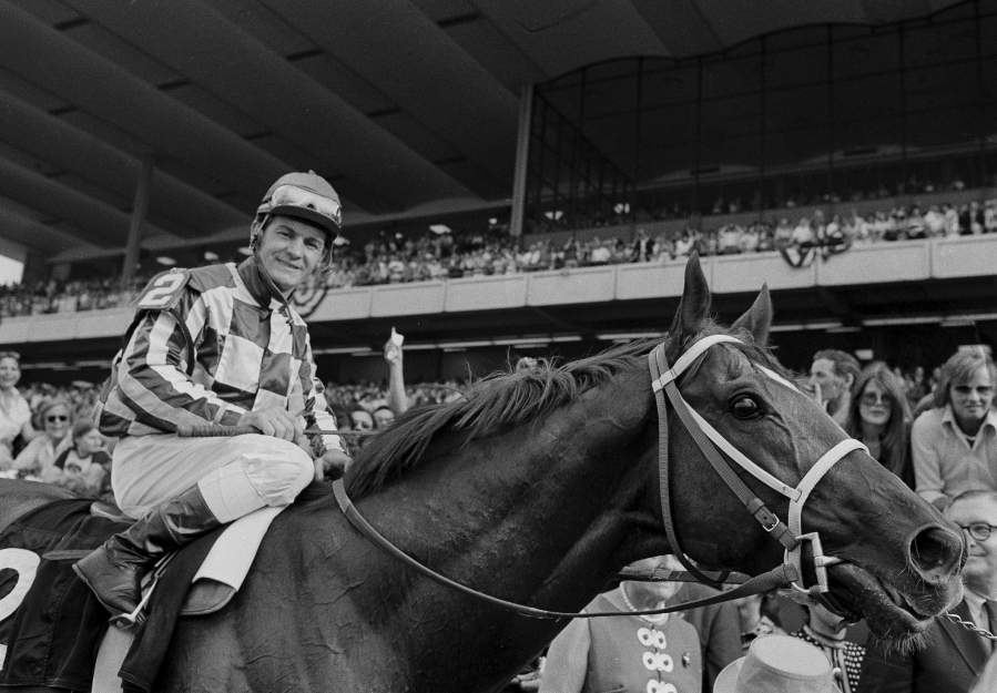 FILE - Jockey Ron Turcotte walks Secretariat towards the winners circle after they captured the Triple Crown by winning the Belmont Stakes before a crowd of 70,000 fans at Belmont Park in Elmont, N.Y., June 9, 1973.