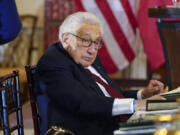 Former U.S. Secretary of State Henry Kissinger attends a luncheon with French President Emmanuel Macron, U.S. Vice President Kamala Harris and U.S. Secretary of State Antony Blinken on Dec. 1 at the State Department in Washington.