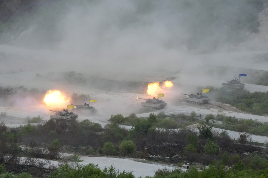 FILE - South Korean army's K-2 tanks fire during a South Korea-U.S. joint military drills at Seungjin Fire Training Field in Pocheon, South Korea, Thursday, May 25, 2023. North Korea on Tuesday, May 30, confirmed plans to launch its first military spy satellite in June and described such capacities as crucial for monitoring the United States' "reckless" military exercises with rival South Korea.