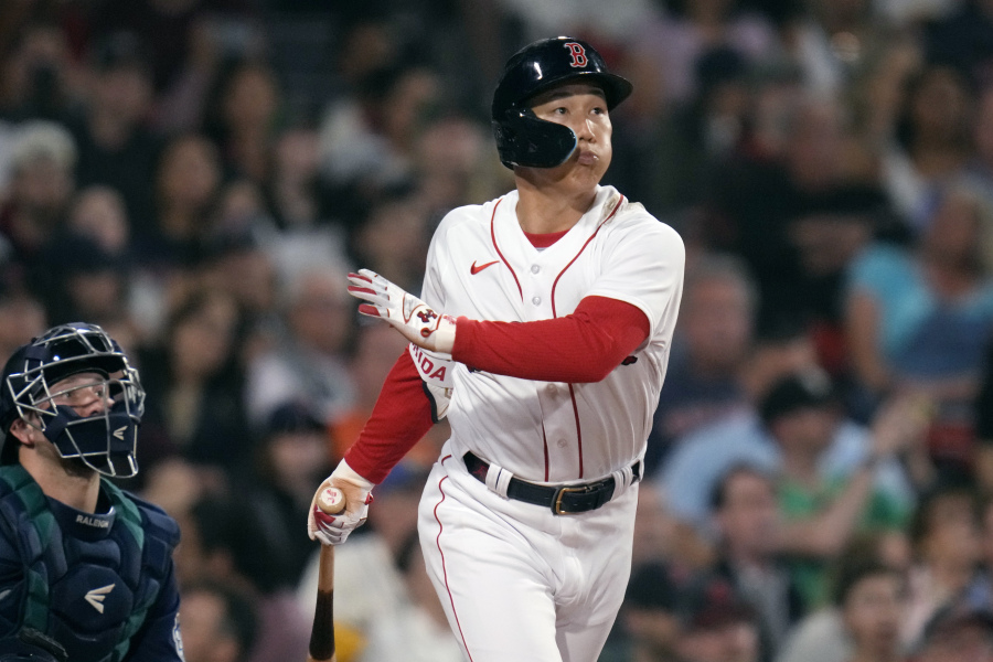 Boston Red Sox's Masataka Yoshida watches the flight of his RBI double in the fifth inning of a baseball game against the Seattle Mariners at Fenway Park, Tuesday, May 16, 2023, in Boston.