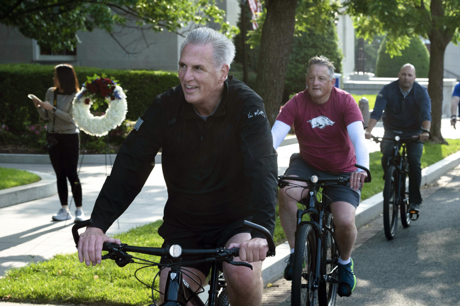 House Speaker Kevin McCarthy, of Calif., leads fellow members of Congress and law enforcement officers as they arrive at the National Law Enforcement Officers Memorial, in Washington, Thursday, May 11, 2023. McCarthy lead his "Back the Blue" bike tour of Washington, before laying wreaths at the memorial.