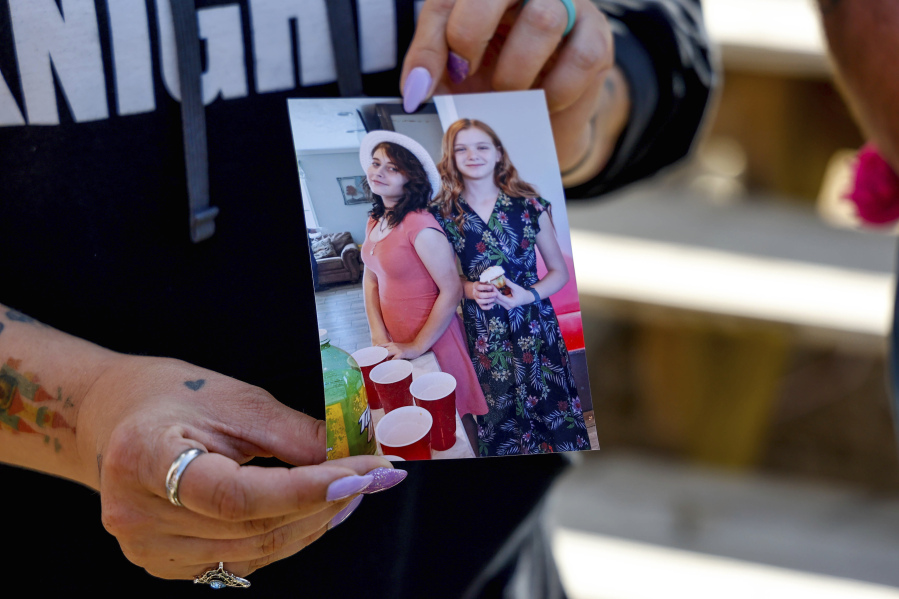 Ashleigh Webster shows a photo of Ivy Webster and Tiffany Guess at her home in Henryetta, Okla., Tuesday, May 2, 2023. (Nathan J.