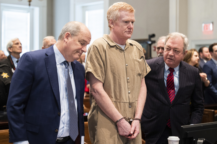 FILE - Alex Murdaugh speaks with his legal team before he is sentenced to two consecutive life sentences for the murder of his wife and son by Judge Clifton Newman at the Colleton County Courthouse, March 3, 2023, in Walterboro, S.C. A South Carolina grand jury Tuesday, April 25, charged Murdaugh with two counts of tax evasion after prosecutors reviewed his final years of tax returns before he headed behind bars.