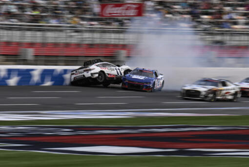 Chase Elliott (9) and Denny Hamlin (11) collide during a NASCAR Cup Series auto race at Charlotte Motor Speedway, Monday, May 29, 2023, in Concord, N.C.
