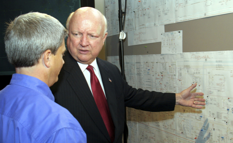 FILE - Samuel Bodman, U.S. Energy Secretary under President George W. Bush, right, visits a transmission control room alongside Georgia Power Co. transmission system operations manager Jeff Stansell at Georgia Power Co. headquarters, in Atlanta on Aug. 4, 2006. Bodman and the Bush administration supported efforts to build new nuclear reactors, including two new reactors at Georgia Power's Plant Vogtle.