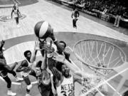 FILE - Denver Nuggets' Bobby Jones, second left, Nets' Julius Erving, fourth left, and New York Nets' Jim Eakins, right,  battle for a rebound during the ABA championship playoff game at the Nassau Coliseum in Uniondale, N.Y., on May 14, 1976.  The Denver Nuggets are the last of the four ABA teams that merged with the NBA to reach the Finals and is stirring up fond memories of the defunct league.
