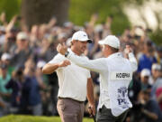 Brooks Koepka celebrates with his caddie Ricky Elliott after winning the PGA Championship at Oak Hill Country Club on Sunday in Pittsford, N.Y.