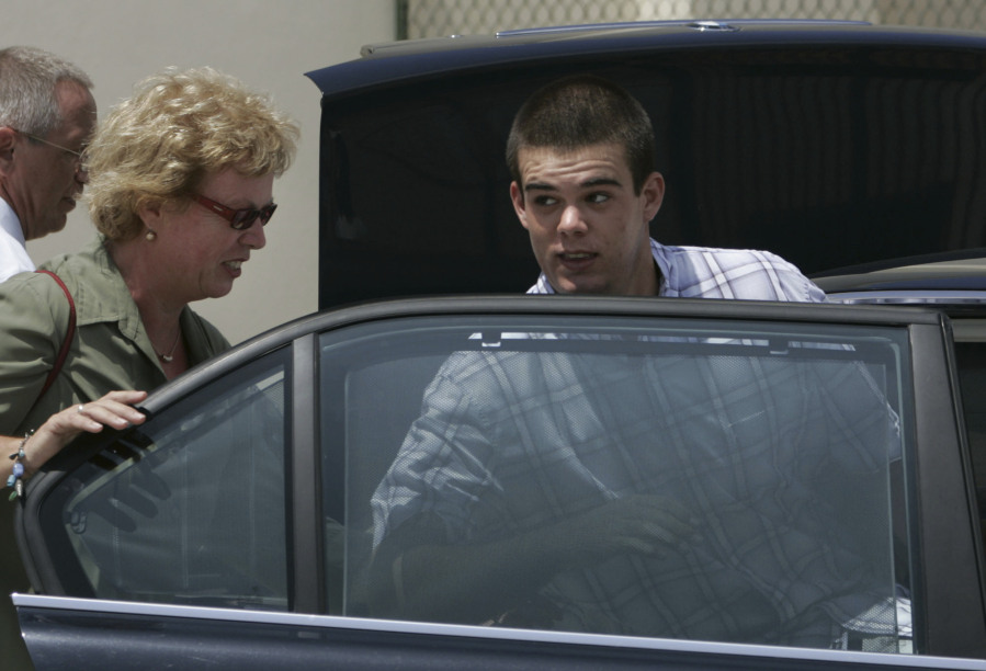 FILE - Dutch teen Joran van der Sloot, 18, enters his family's car as his mother Anita closes the door after he was conditionally released from the KAI jail in San Nicolas, Aruba, Sept. 3, 2005. Van der Sloot, the prime suspect in the 2005 disappearance of American student Natalee Holloway on a Dutch Caribbean island, is facing extradition from Peru in 2023 to face criminal charges in the United States, while he has never been charged in connection with her disappearance.