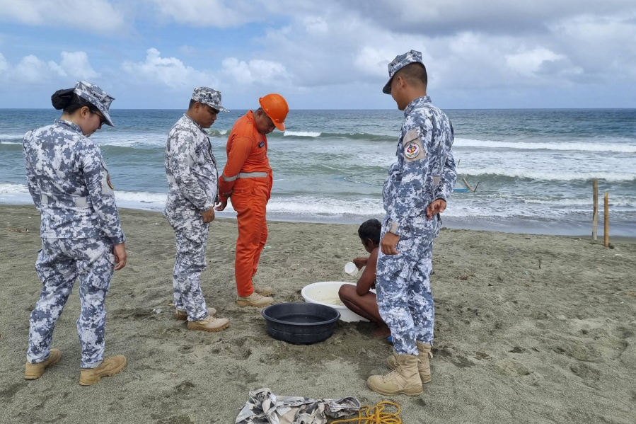 In this handout photo provided by the Philippine Coast Guard, Philippine Coast Guard personnel check on a fisherman while conducting patrol along shore lines in Ilocos Norte province, northern Philippines, as they prepare for the possible effects of Typhoon Mawar on Monday, May 29, 2023. Philippine officials began evacuating thousands of villagers, shut down schools and offices and imposed a no-sail ban Monday as Typhoon Mawar approached the country's northern provinces a week after battering the U.S. territory of Guam.