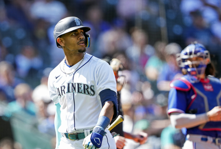 Seattle Mariners' Julio Rodriguez looks on after striking out against the Texas Rangers during the ninth inning of a baseball game Wednesday, May 10, 2023, in Seattle. The Rangers won 4-3.