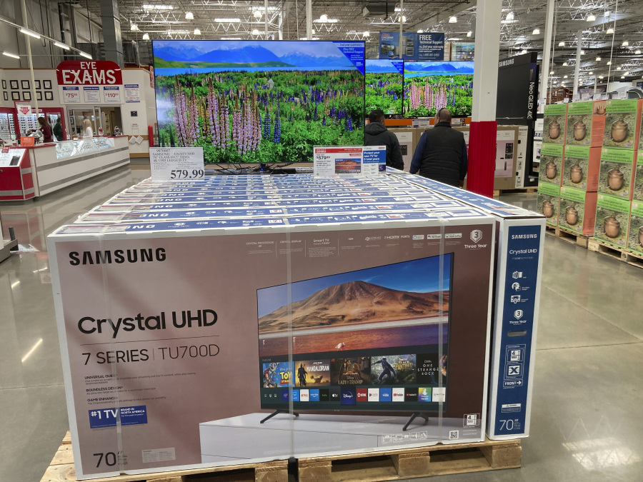 Shoppers pass by a display of big-screen televisions in a Costco warehouse Wednesday, April 26, 2023, in Sheridan, Colo. On Tuesday, the Commerce Department releases U.S. retail sales data for April.