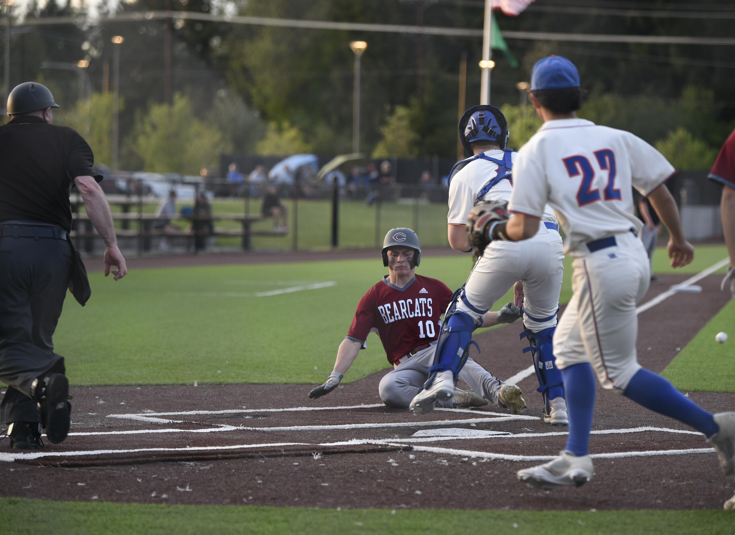 W.F. West's Lane Sahlin slides into home plate ahead of a Ridgefield throw during the Class 2A District 4 baseball semifinals on Wednesday, May 10, 2023 at Ridgefield Outdoor Recreation Complex.