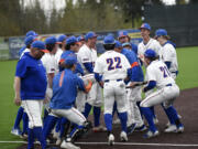 The members of the Ridgefield baseball team celebrate their 6-2 win over Mark Morris in a 2A Greater St. Helens League baseball game at the Ridgefield Outdoor Recreation Complex on Monday, May 1, 2023.
