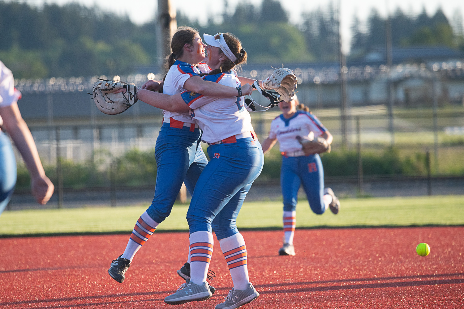 Elizabeth Peery hugs Maizy Whitlow after the final out of Ridgefield's 4-3 win over Tumwater in the semifinals of the 2A District 4 tournament, May 18 at Rec Park in Chehalis.