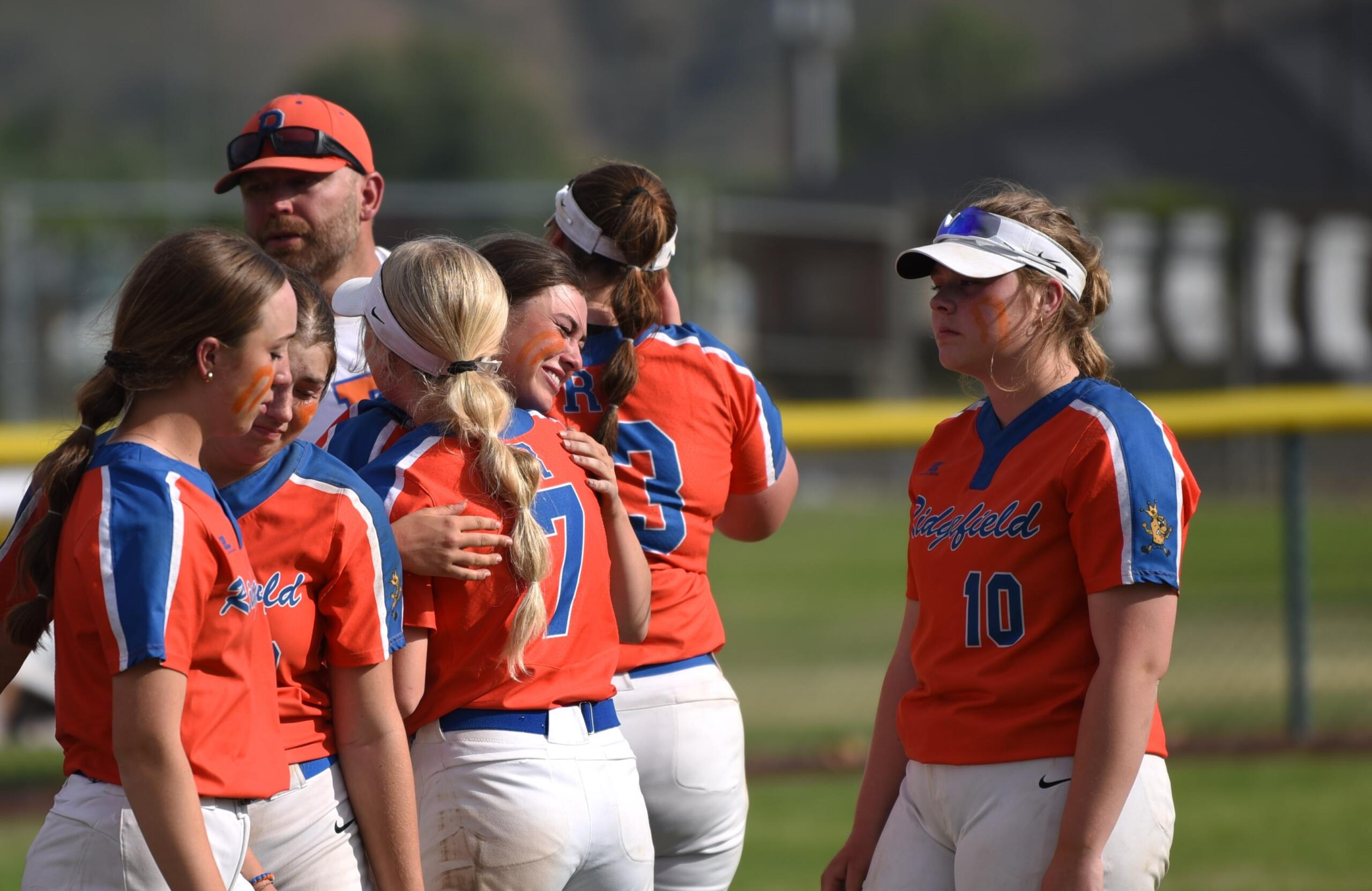 Ridgefield softball players embrace after the Class 2A state championship game against North Kitsap on Saturday in Selah. The Spudders' second-place finish was the second highest in program history.
