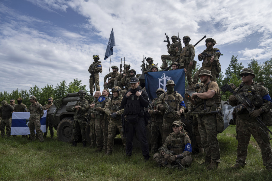 Fighters of Russian Volunteer Corps prepare for the press conference not far from the border in Sumy region, Ukraine, Wednesday, May 24, 2023. Russia's military said Tuesday it quashed what appeared to be one of the most serious cross-border attacks from Ukraine since the war began, claiming to have killed more than 70 attackers in a battle that lasted around 24 hours.