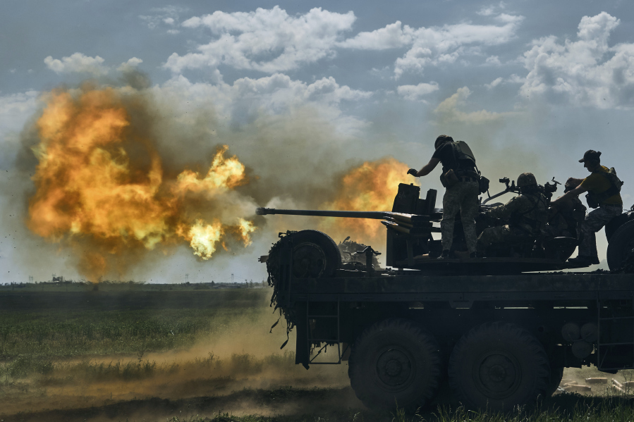 Ukrainian soldiers fire a cannon near Bakhmut, an eastern city where fierce battles against Russian forces have been taking place, in the Donetsk region, Ukraine, Monday, May 15, 2023.