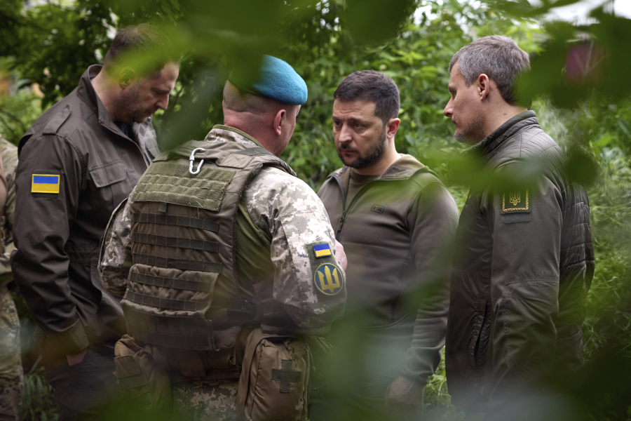 In this photo provided by the Ukrainian Presidential Press Office, Ukrainian president Volodymyr Zelenskyy, second right, listens to military commander as he visits the Donetsk region, Ukraine, Tuesday, May 23, 2023.