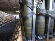 FILE - Pallets of 155 mm shells ultimately bound for Ukraine are loaded by the 436th Aerial Port Squadron, April 29, 2022, at Dover Air Force Base, Del. U.S. officials say a military aid package for Ukraine that is expected to be announced this week will total up to $300 million, and will include additional munitions for drones.