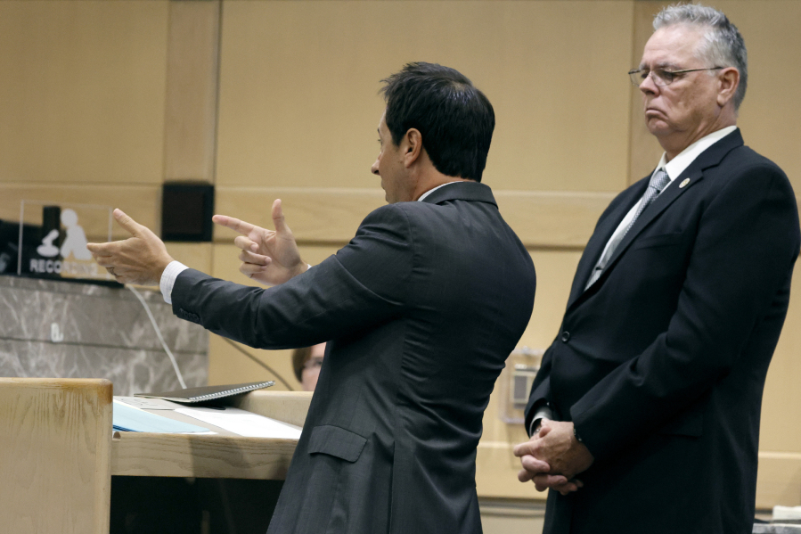 Defense lawyer Mark Eiglarsh gestures as if he is holding a gun as he speaks during a hearing in the case of former Marjory Stoneman Douglas High School School Resource Officer Scot Peterson, right, at the Broward County Courthouse in Fort Lauderdale on Tuesday, May 30, 2023. Broward County prosecutors charged Peterson, a former Broward Sheriff's Office deputy, with criminal charges for failing to enter the 1200 Building at the school and confront the shooter as he perpetuated the Valentine's Day 2018 Massacre.