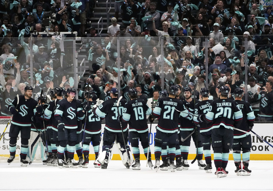 Fans cheer as the Seattle Kraken celebrate a 6-3 win over the Dallas Stars in Game 6 of an NHL hockey Stanley Cup second-round playoff series, Saturday, May 13, 2023, in Seattle.