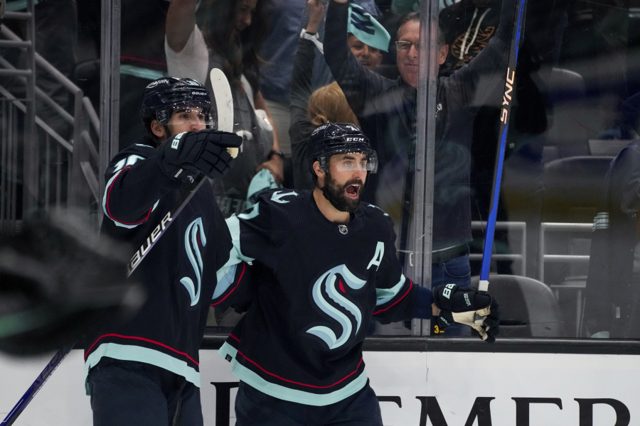 Seattle Kraken center Matty Beniers (10) celebrates his goal against the Dallas Stars with teammate Jordan Eberle, right, during the third period of Game 6 of an NHL hockey Stanley Cup second-round playoff series Saturday, May 13, 2023, in Seattle. The Kraken won 6-3.