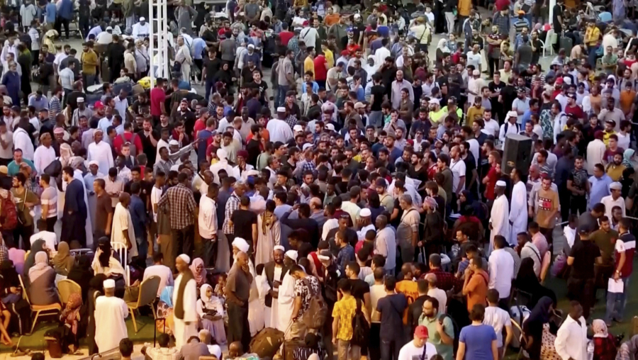 In this screen grab taken from video, Sudanese and foreigners arrive in Port Sudan, the country's main seaport, as they wait to be evacuated out of Sudan, Monday May 1, 2023. Sudanese fleeing the fighting between rival generals in their capital flooded an already overwhelmed city on the Red Sea and Sudan's northern borders with Egypt, as explosions and gunfire echoed Tuesday in Khartoum.