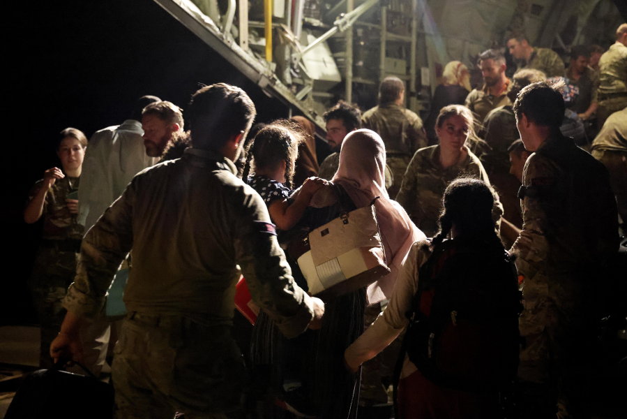 In this photo released by the UK Ministry of Defence the last evacuees and military personnel board an RAF aircraft bound for Cyprus from Wadi Seidna Air Base in Sudan, April 29, 2023.