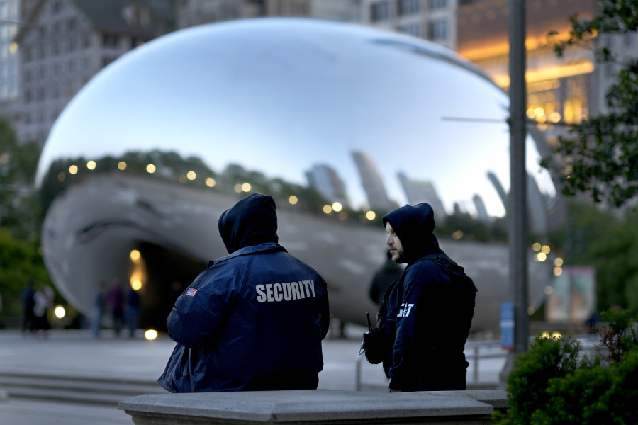 *Private security personnel patrol the area around Anish Kapoor's stainless steel sculpture Cloud Gate, also known as "The Bean," in Chicago's Millennium Park Thursday, May 25, 2023. Chicago is heading into the Memorial Day weekend hoping to head off violence that tends to surge with rising temperatures of summer. Even the state of Illinois is assisting by sending in what it's called "peacekeepers" in an attempt to deescalate violent situations.