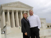 FILE - Michael and Chantell Sackett of Priest Lake, Idaho, pose for a photo in front of the Supreme Court in Washington on Oct. 14, 2011. The Supreme Court said Monday, May 25, 2023, said it will consider reining in federal regulation of private property under the nation's main anti-water pollution law, the Clean Water Act. The justices agreed to hear a business-backed appeal from Chantell and Michael Sackett, who have wanted to build a home close to Priest Lake in Idaho for 15 years and won an earlier round in their legal fight at the Supreme Court. (AP Photo/Haraz N.