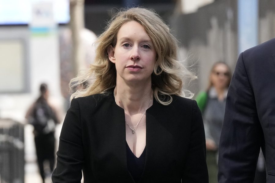 FILE - Former Theranos CEO Elizabeth Holmes leaves federal court in San Jose, Calif., March 17, 2023. Holmes has asked a federal judge, Wednesday, May 17, 2023, to allow her to remain free through the Memorial Day weekend before surrendering to authorities on May 30, to begin her more than 11-year prison sentence for defrauding investors in a blood-testing scam.