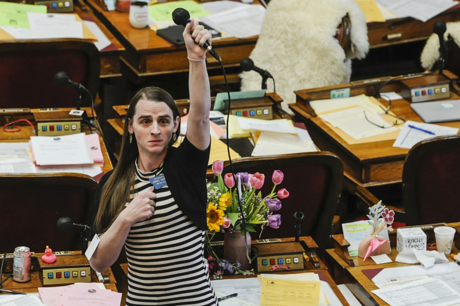 FILE - State Rep. Zooey Zephyr, D-Missoula, alone on the house floor, stands in protest as demonstrators are arrested in the house gallery, Monday, April 24, 2023, in the Montana State Capitol in Helena, Mont. The banishment of transgender lawmaker Zephyr from Montana's House floor has showcased the rising power of hardline conservatives who are leveraging divisive social issues to gain political influence.